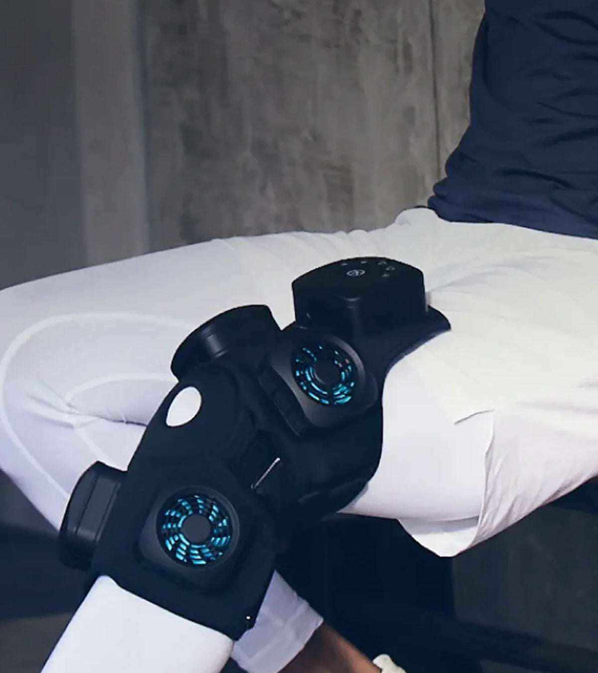 Person wearing a black cooling knee brace with integrated blue LED fans