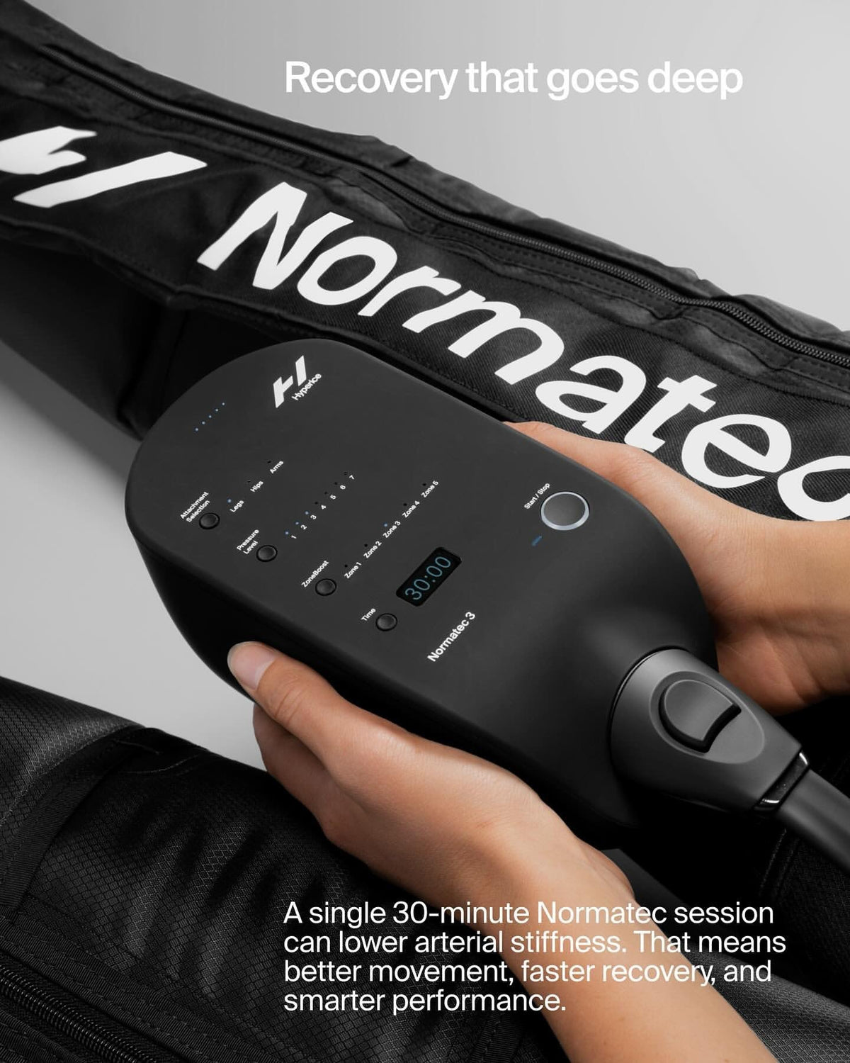 Close-up of a person operating a Normatec 3 compression recovery device control unit.