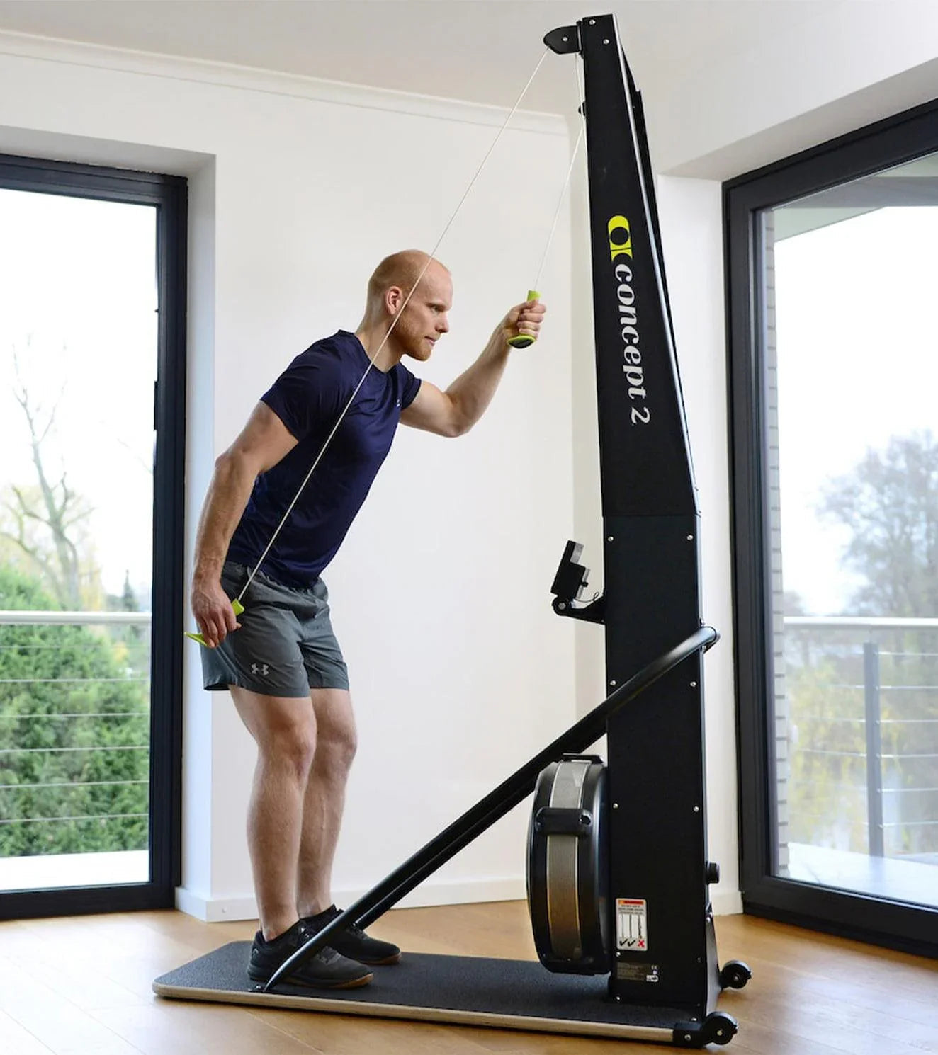 Man working out indoors on Concept2 SkiErg functional fitness machine