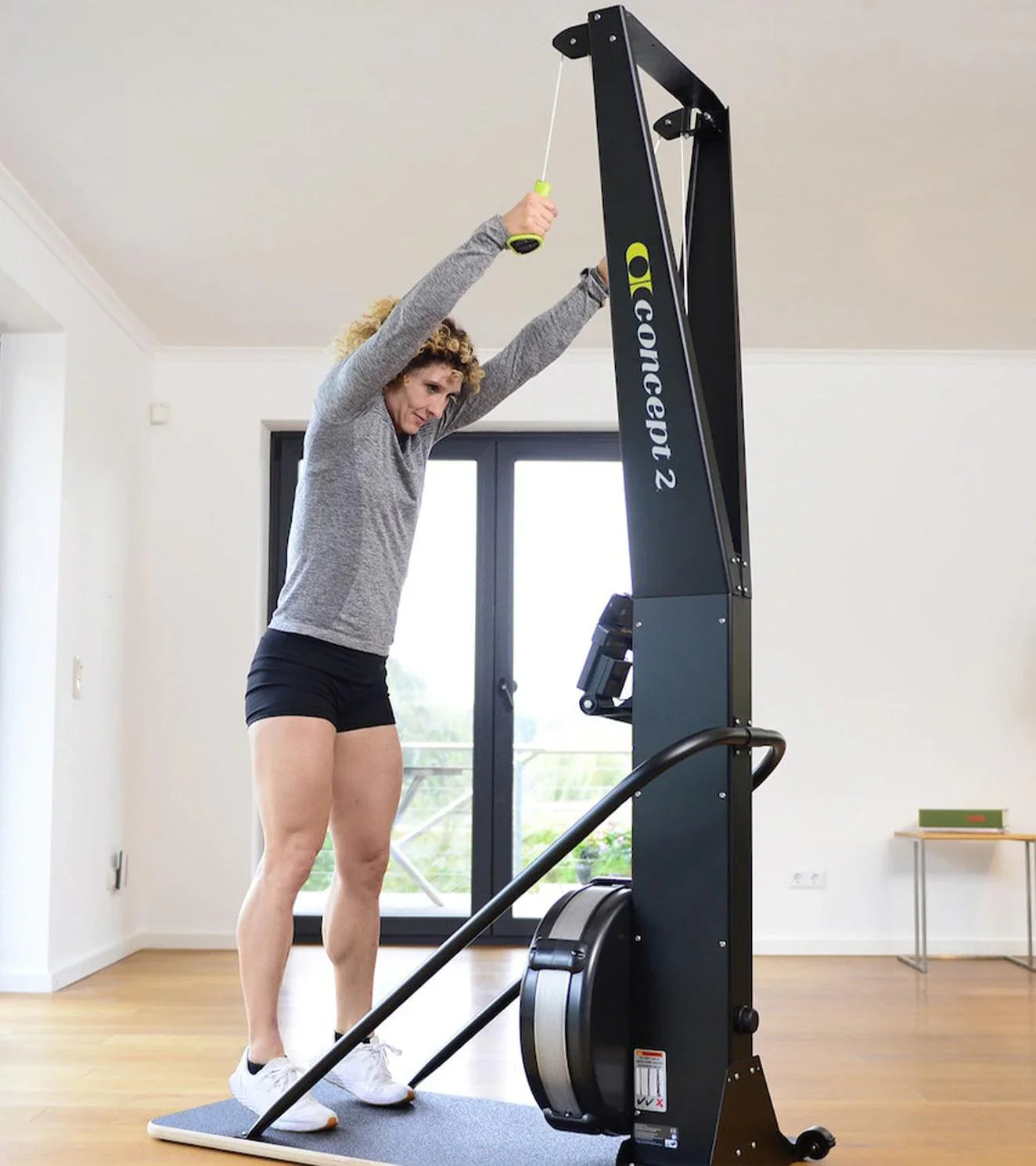 Athlete using Concept2 SkiErg machine in a bright indoor fitness space