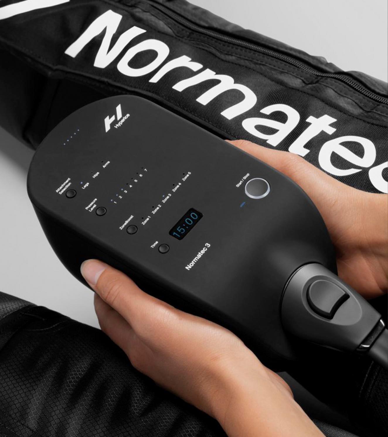 Hands holding Normatec 3 compression device for athletic recovery and circulation support
