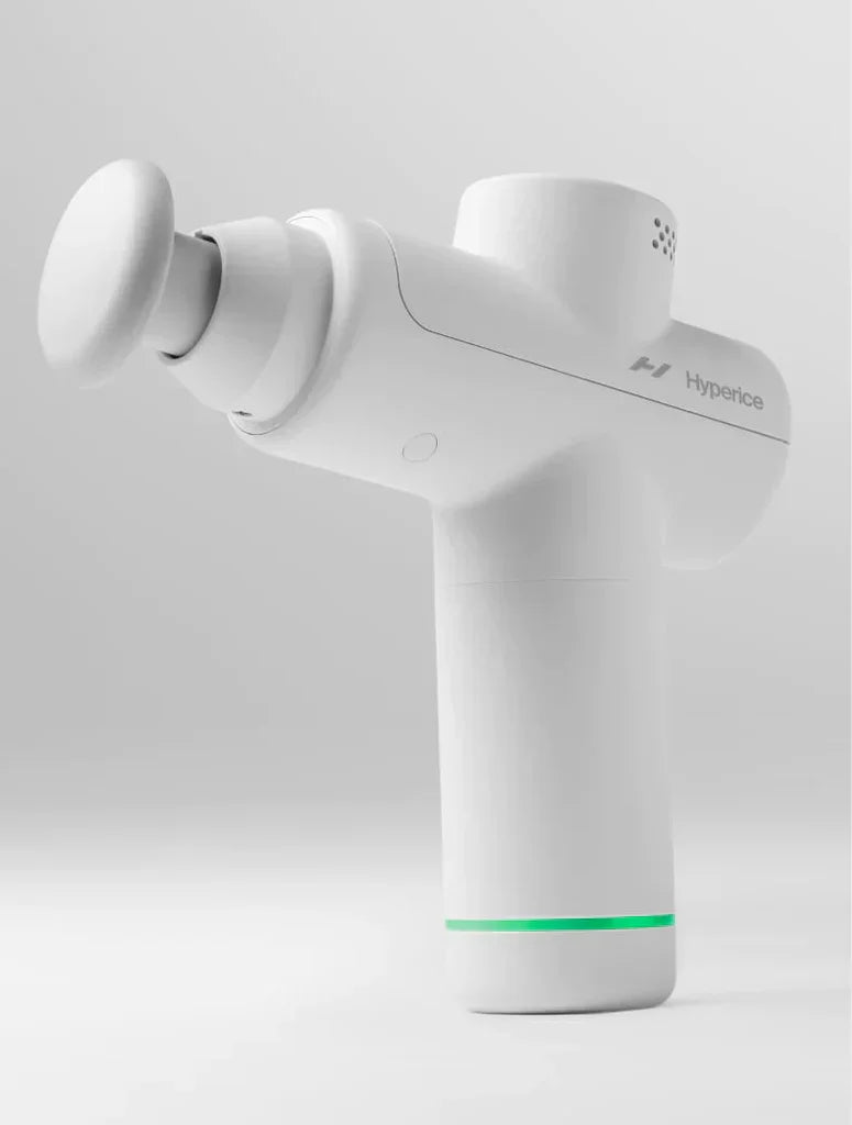 White Hypervolt Go 2 massage gun with green LED ring on gray background