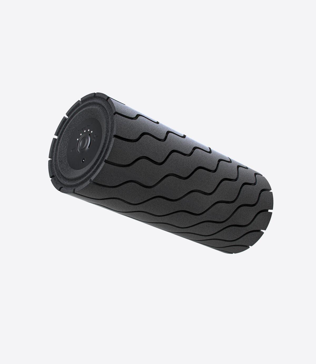 Black textured vibrating foam roller for muscle recovery on a plain background