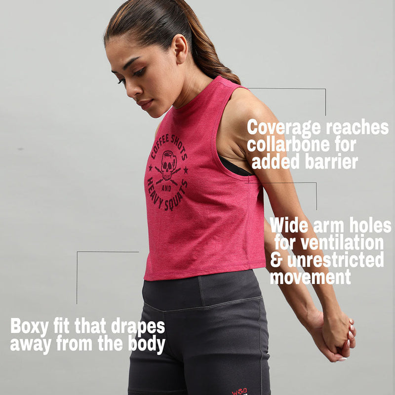 Woman wearing a pink boxy-fit functional fitness crop top with graphic print and black leggings.
