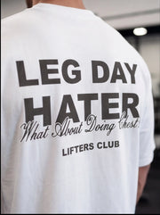 White gym t-shirt with 'LEG DAY HATER' graphic, perfect for lifters and fitness enthusiasts.