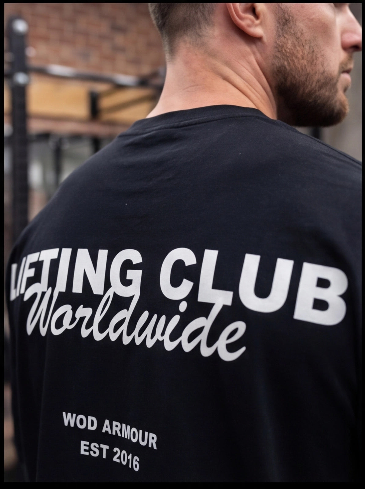 Man wearing black 'Lifting Club Worldwide' t-shirt by WOD Armour, gym fitness apparel