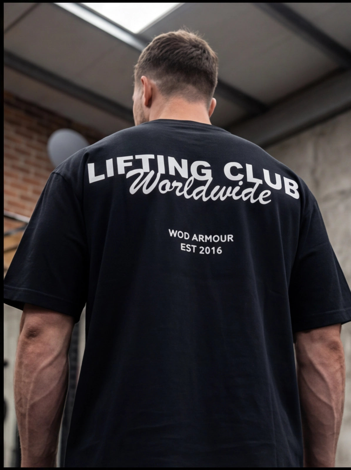 Man wearing black 'Lifting Club Worldwide' gym t-shirt, WOD Armour fitness apparel for athletes
