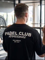 Man lifting barbell in gym wearing black Padel Club Worldwide WOD Armour t-shirt, functional fitness apparel