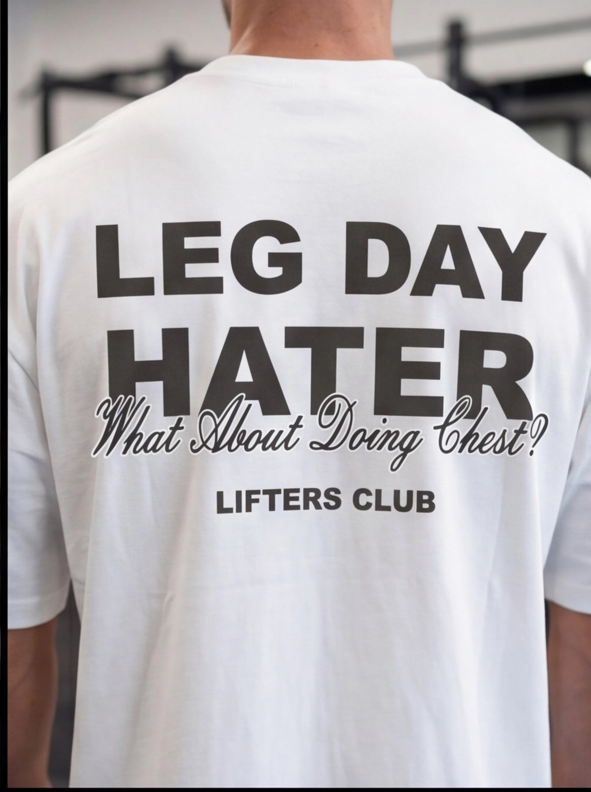 White gym t-shirt with 'Leg Day Hater' graphic, perfect for lifters and fitness enthusiasts.