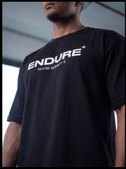 Black ENDURE fitness t-shirt with coordinates, worn by athlete in gym setting for functional training