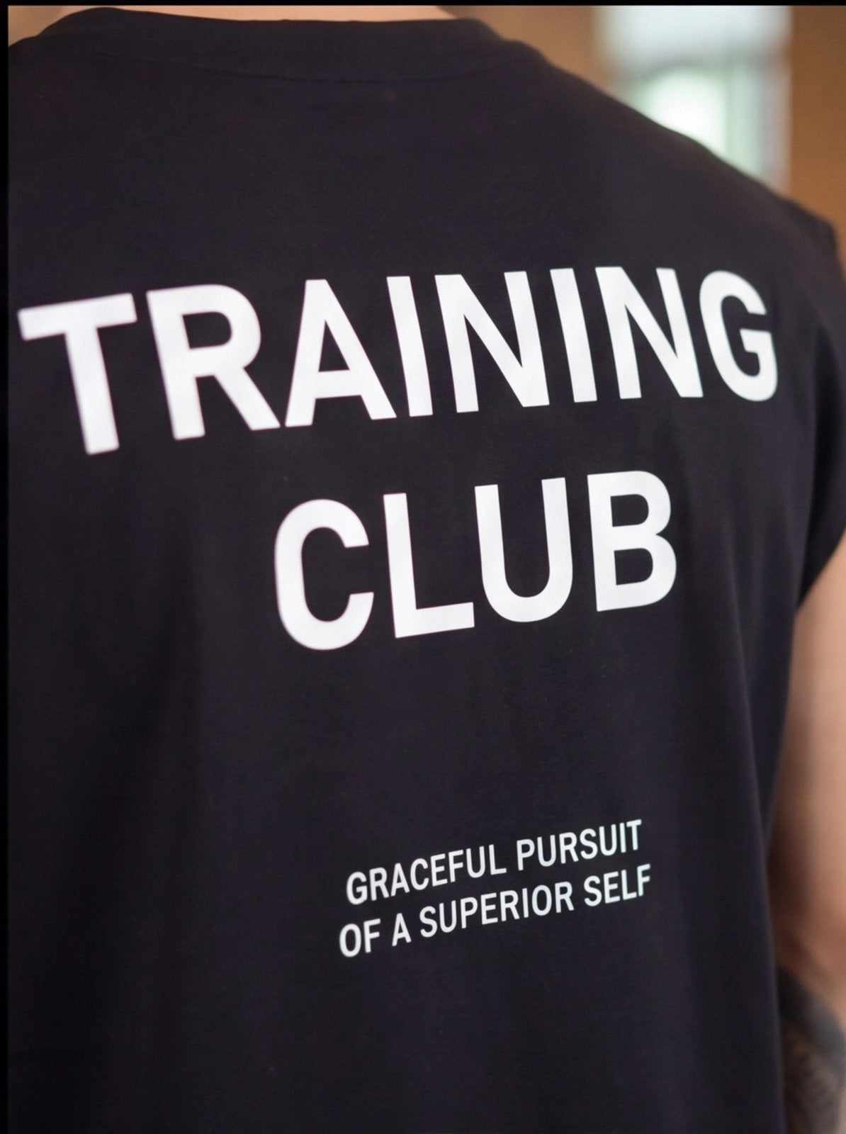 Black Training Club t-shirt with 'Graceful Pursuit of a Superior Self' slogan, ideal for functional fitness athletes.