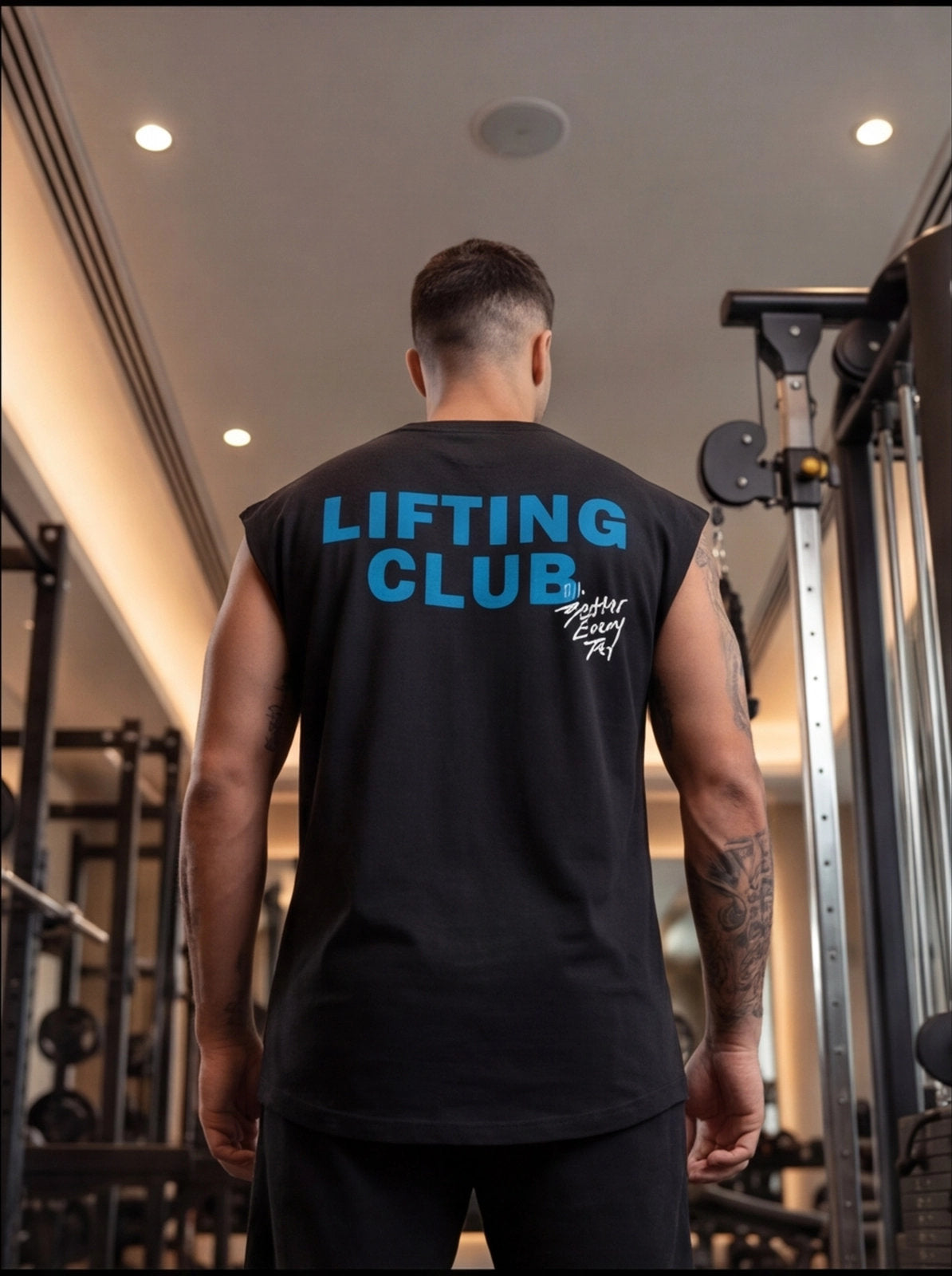 Man wearing black 'LIFTING CLUB' gym tank top in fitness center, showcasing athletic wear for strength training.
