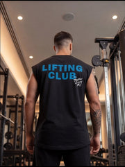 Man wearing black 'LIFTING CLUB' gym tank top in fitness center, showcasing athletic wear for strength training.