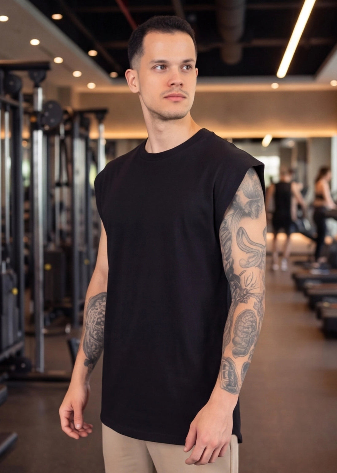 Man in black sleeveless gym shirt at functional fitness gym, showcasing athletic wear for training