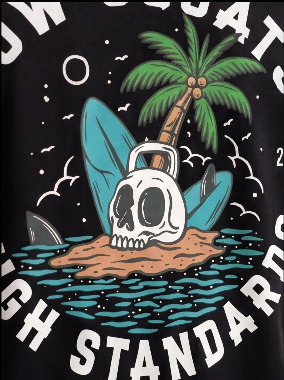 Black fitness tee with skull, palm tree, surfboard, and kettlebell on island graphic, 'High Standards' text
