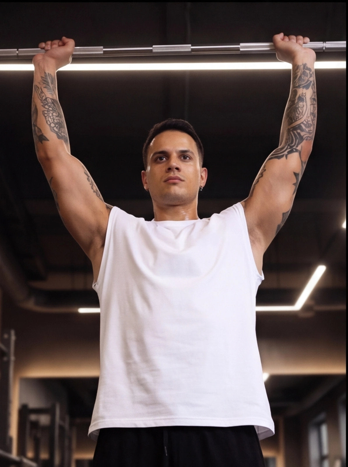 Athlete gripping pull-up bar in gym, showcasing strength training and functional fitness gear.