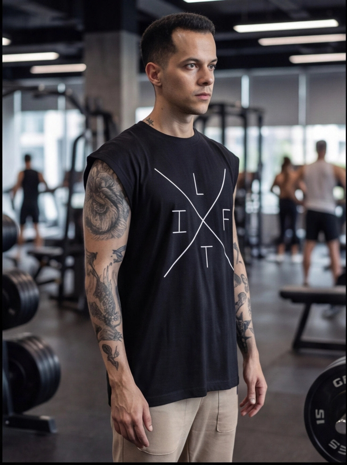 Man in black sleeveless gym shirt with 'LIFT' graphic, tattoos, in fitness center
