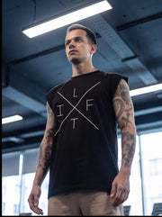 Man wearing black sleeveless fitness shirt with 'LIFT' graphic, ideal for functional training and gym workouts.