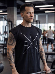 Man in black sleeveless gym shirt with 'LIFT' graphic, holding barbell in fitness center