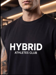 Man wearing black HYBRID ATHLETES CLUB t-shirt, fitness apparel for athletes and gym training