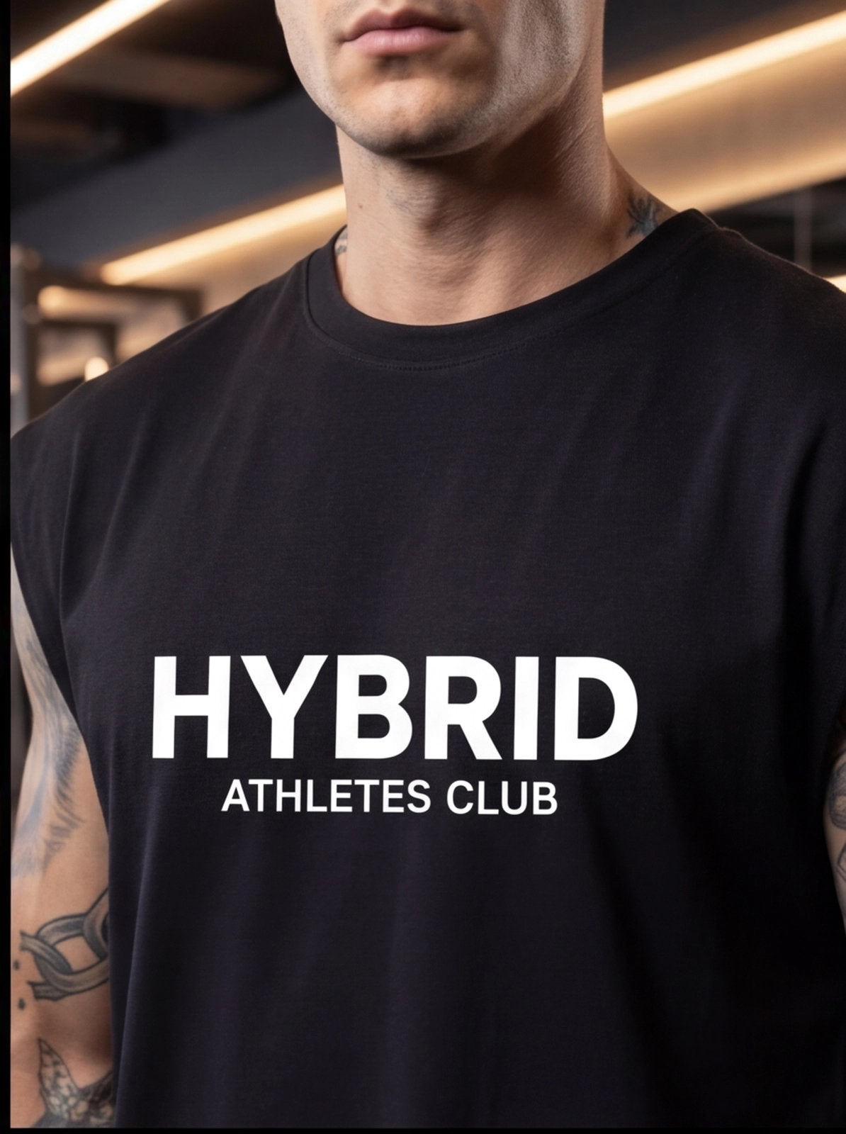 Man wearing black HYBRID ATHLETES CLUB t-shirt, fitness apparel for athletes and gym training