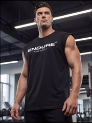 Man in black ENDURE sleeveless gym shirt, showcasing athletic build in fitness studio