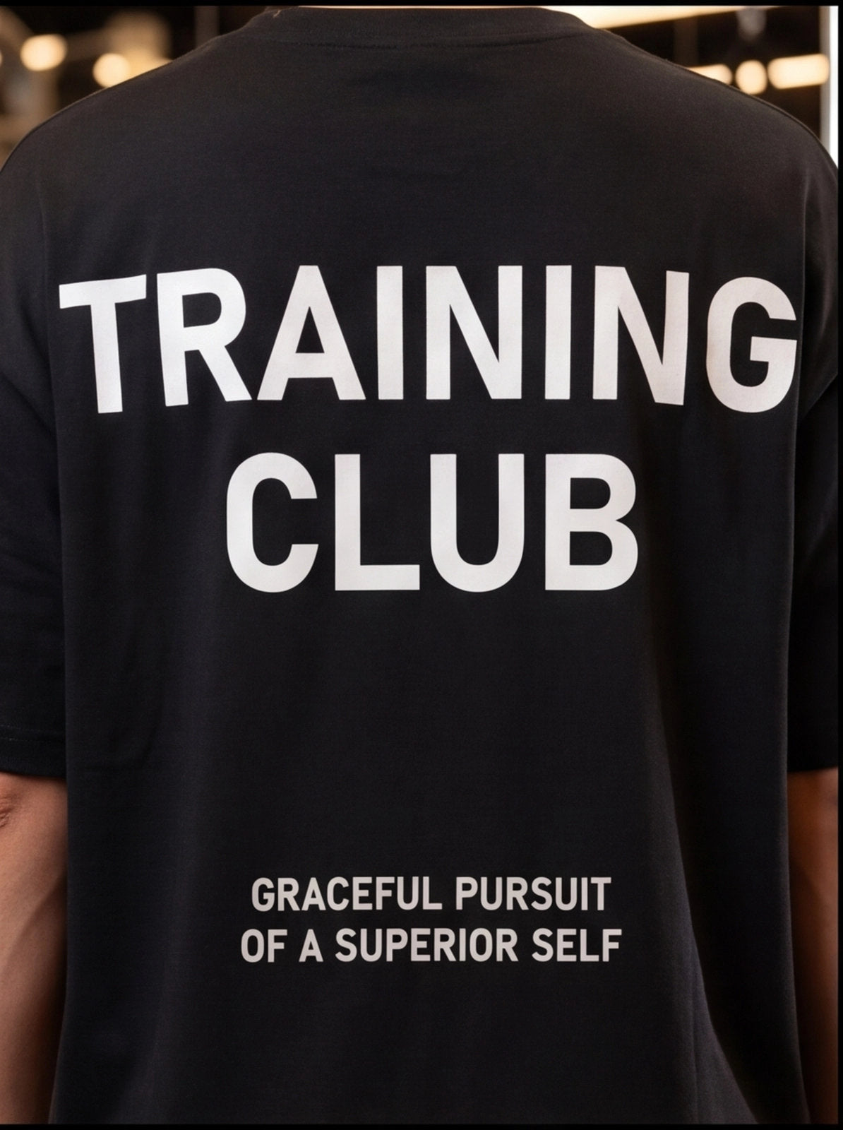 Black Training Club t-shirt with 'Graceful Pursuit of a Superior Self' slogan, ideal for functional fitness and athletic performance.