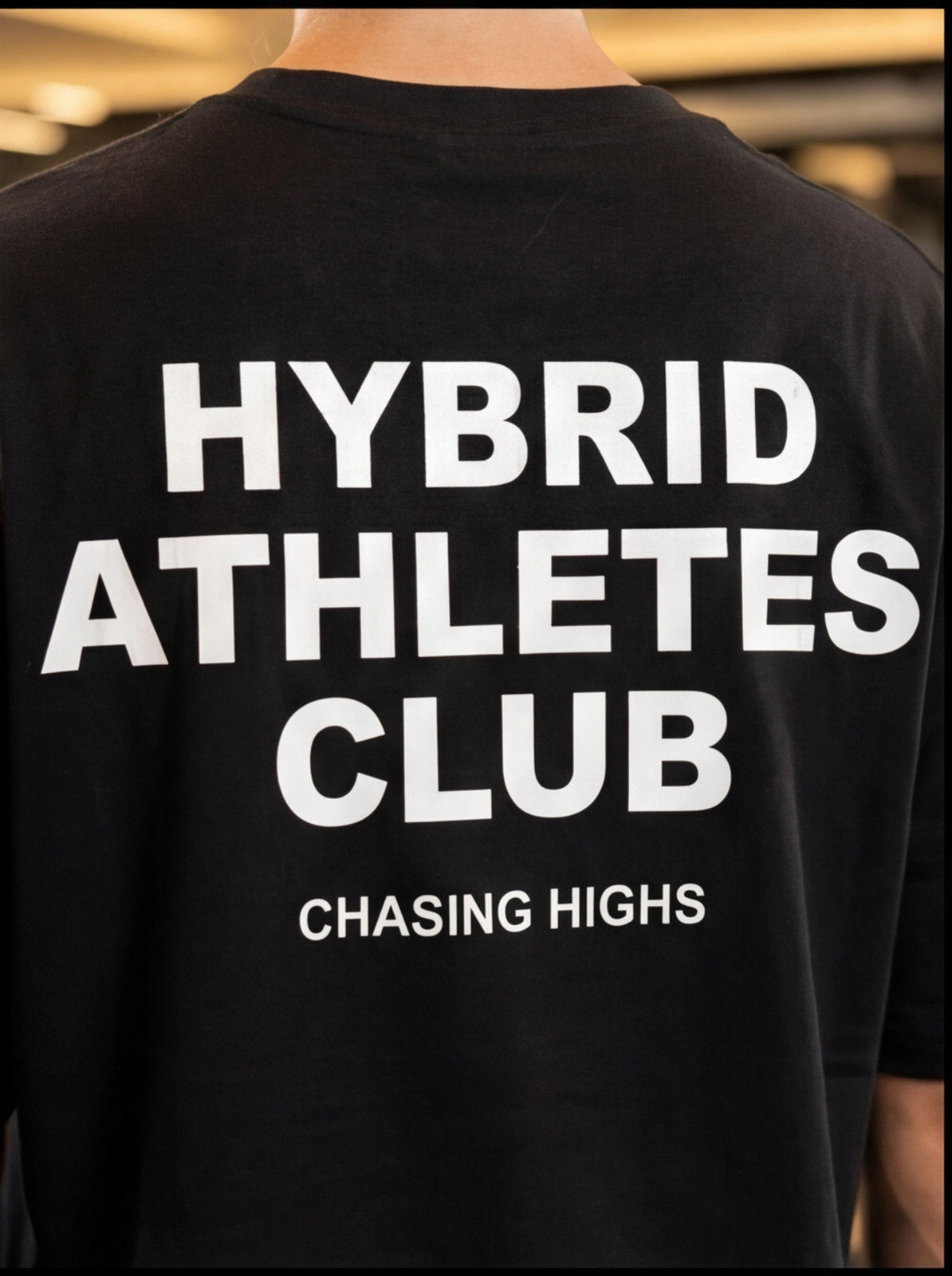 Black HYBRID ATHLETES CLUB t-shirt with 'CHASING HIGHS' text, designed for functional fitness and athletic performance.