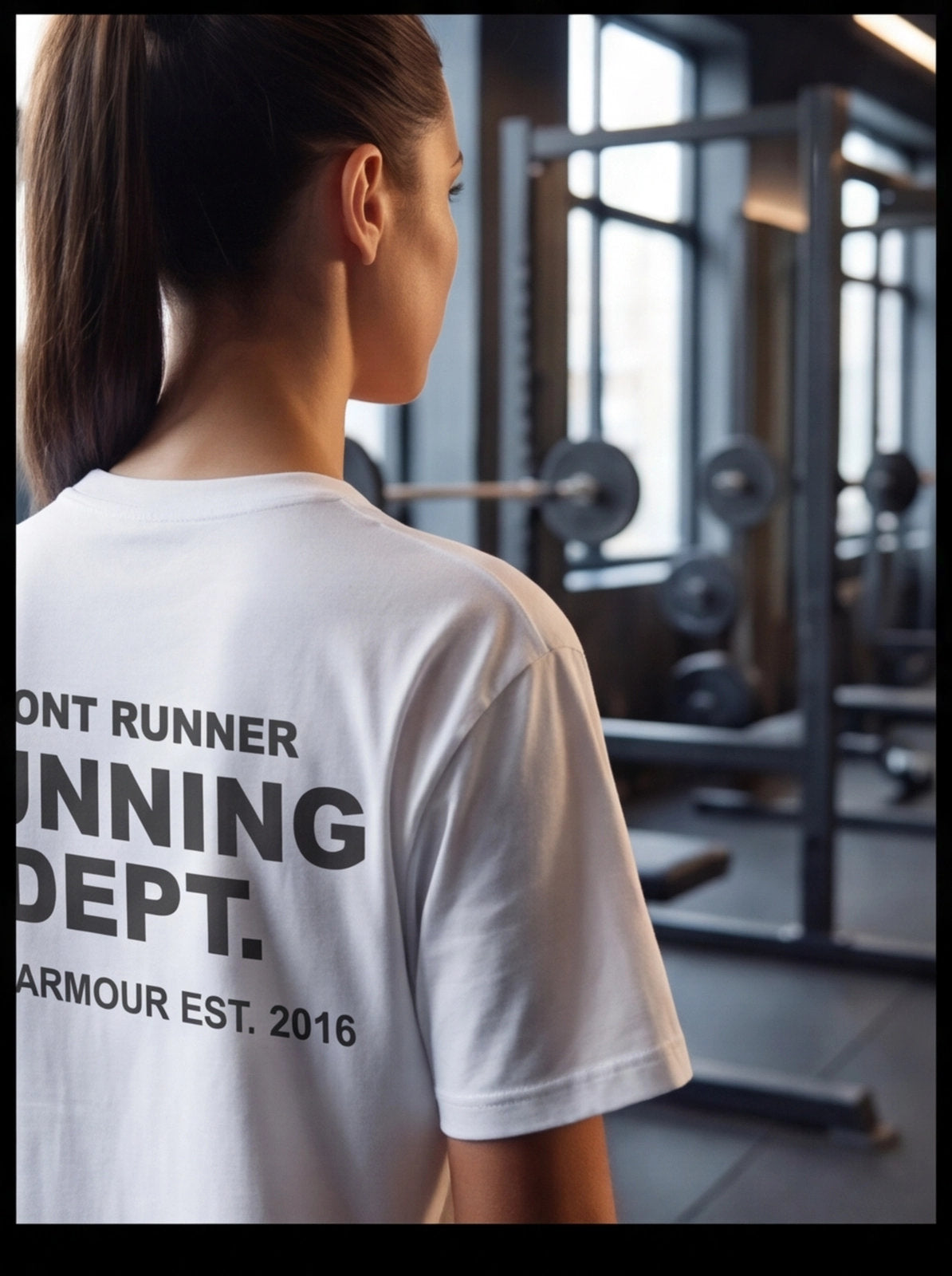 Woman in gym wearing white 'Front Runner Running Dept.' t-shirt, functional fitness apparel for athletes