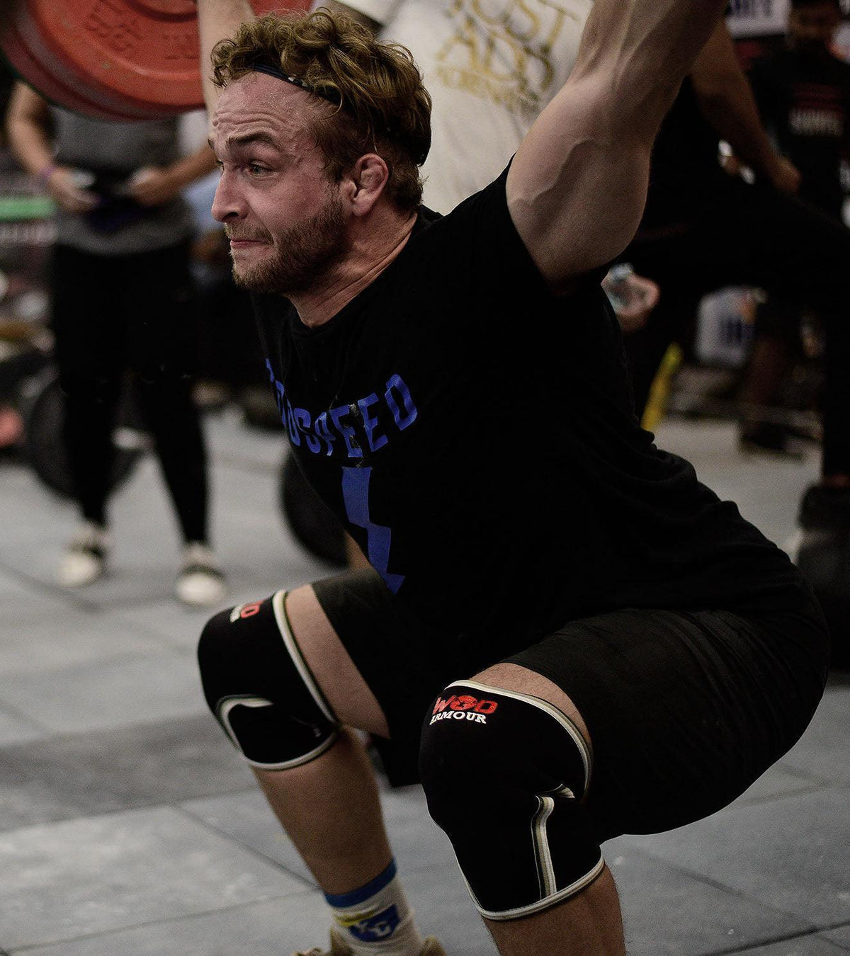 Athlete wearing WOD Armour knee sleeves performing a heavy overhead squat
